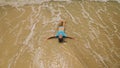 Woman lying on shallow water sea. Happy slightly tipsy woman enj