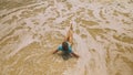 Woman lying on shallow water sea. Happy slightly tipsy woman enj