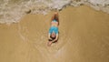 Woman lying on shallow water sea. Happy slightly tipsy woman enj