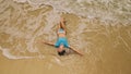 Woman lying on shallow water sea. Happy slightly tipsy woman enj