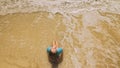 Woman lying on shallow water sea. Happy slightly tipsy woman enj