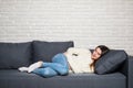 Woman lying on sofa looking sick in the living room