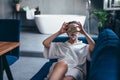 Woman lying on a sofa with a mask on her face and pieces of cucumber on her eyes Royalty Free Stock Photo