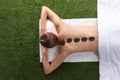 Woman lying with spa stones on back Royalty Free Stock Photo