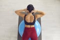 Woman lying on stability ball doing back extension exercise for healthy fit body