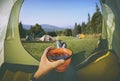 Woman lying in a tent with coffee Royalty Free Stock Photo