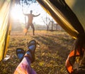 Woman lying in a tent with coffee ,view of mountains and sky Royalty Free Stock Photo