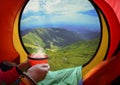 Woman lying in a tent with coffee Royalty Free Stock Photo