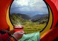 Woman lying in a tent with coffee Royalty Free Stock Photo