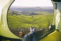 Woman lying in tent with a view of mountain and valley Royalty Free Stock Photo