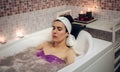 Woman lying in tub doing hydrotherapy treatment