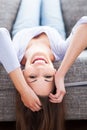 Woman lying upside down on sofa Royalty Free Stock Photo