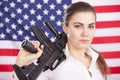 Woman with machine gun over american flag Royalty Free Stock Photo