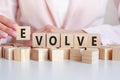Woman made word Evolve with wooden blocks Royalty Free Stock Photo
