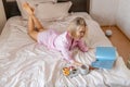 Woman with magazine have breakfast in bed