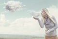 Woman with magical powers creating clouds Royalty Free Stock Photo