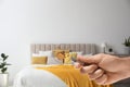 Woman with magnifying glass detecting bed bugs in bedroom Royalty Free Stock Photo