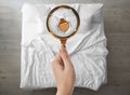 Woman with magnifying glass detecting bed bugs in bedroom Royalty Free Stock Photo