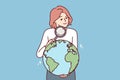 Woman with magnifying glass holds globe studying geography or choosing place for further travel