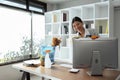 Woman maid cleaning and wiping the computer with microfiber cloth in office Royalty Free Stock Photo