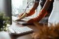 Woman maid cleaning and wiping the keyboard with microfiber cloth at desk in office Royalty Free Stock Photo