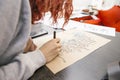 Woman make calligraphy writings, make art on a paper using pen b