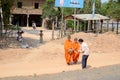 Woman make charity at two monks