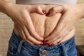 Woman make heart cellulite on belly Royalty Free Stock Photo