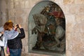 Woman make photo statue of Saint George in the Church of the Nat