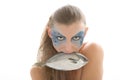 Woman in make-up with fish in mouth