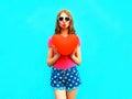 Woman makes an air kiss holds red balloon in the shape of heart Royalty Free Stock Photo