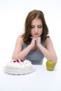 Woman makes choice between cakes Royalty Free Stock Photo