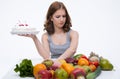 Woman makes choice between cakes Royalty Free Stock Photo