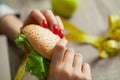 Woman makes a choice between harmful and healthy foods Royalty Free Stock Photo