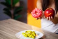 Woman makes a choice between harmful and healthy foods Royalty Free Stock Photo