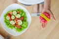 Woman makes a choice between harmful and healthy foods Royalty Free Stock Photo