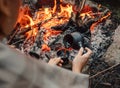 Woman makes a coffee on campfire Royalty Free Stock Photo