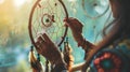 A woman makes a dream catcher. Selective focus.