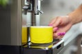 A woman makes fresh flavored coffee with a modern coffee machine in her kitchen