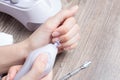 A woman makes her own hardware manicure at home. Close up. Manicure set. Dangerous. Nails. Home care, salon, Spa, beauty, health. Royalty Free Stock Photo