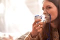 Woman makes inhalation nebulizer at home. holding a mask nebulizer inhaling fumes spray the medication into your lungs sick Royalty Free Stock Photo