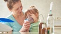 Woman makes inhalation to a child at home. brings the nebulizer mask to his face. inhales the vapor of the medication. the girl Royalty Free Stock Photo