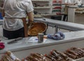 A woman makes a mixture of almonds in a factory of almond candy assortments Royalty Free Stock Photo