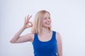 Woman makes ok, good sign with her hand and beaming. Royalty Free Stock Photo