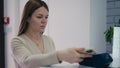 A woman makes payments using short-range wireless data transmission technologies using a mobile phone. NFC in a mobile