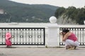 Woman makes photo of a daughter outdoors in sommer, near nice la