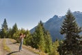 Woman makes photos of Alpine landscape in Carinthia, Austria. Royalty Free Stock Photo