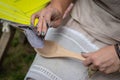 The woman makes traditional handcraft wooden spoon. - Image