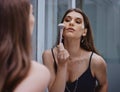 Woman with makeup brush, cosmetic application in mirror and getting ready at home in Los Angeles. Apply luxury beauty Royalty Free Stock Photo