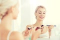 Woman with makeup brush and eyeshade at bathroom Royalty Free Stock Photo